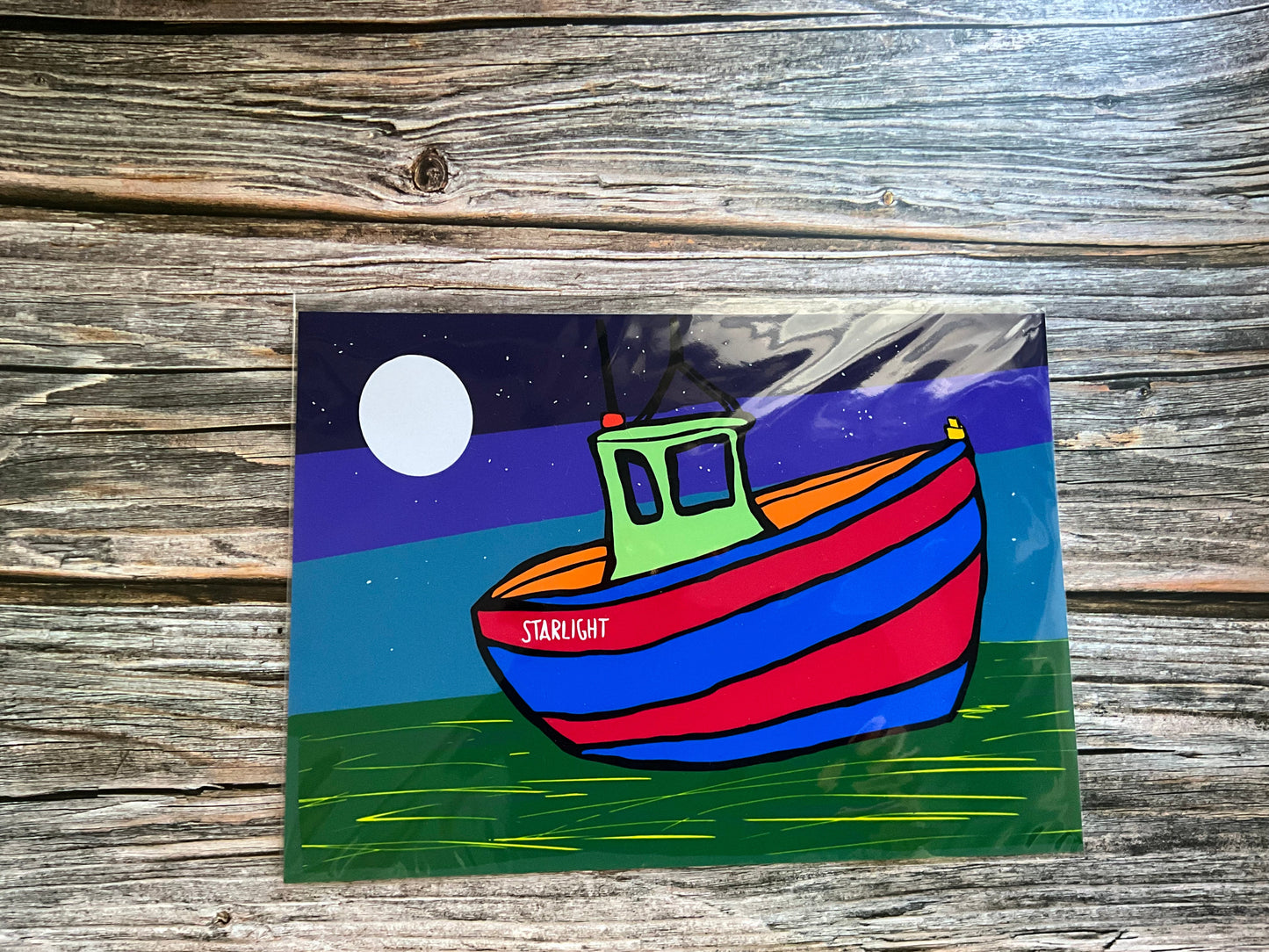 Colorful boat illustration on a wooden surface