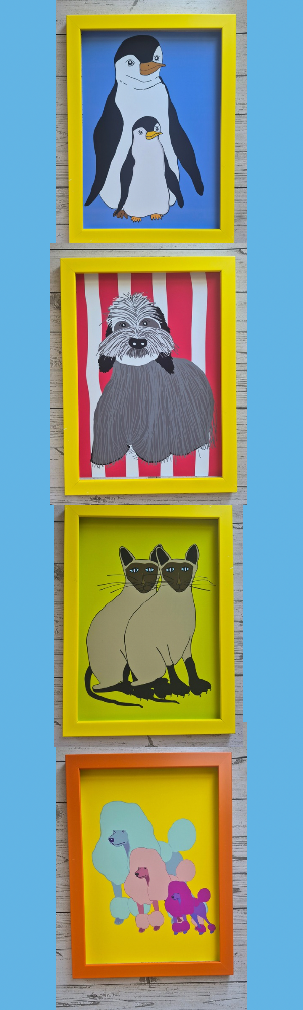 A collection of colourful framed animal art prints on a wooden background.