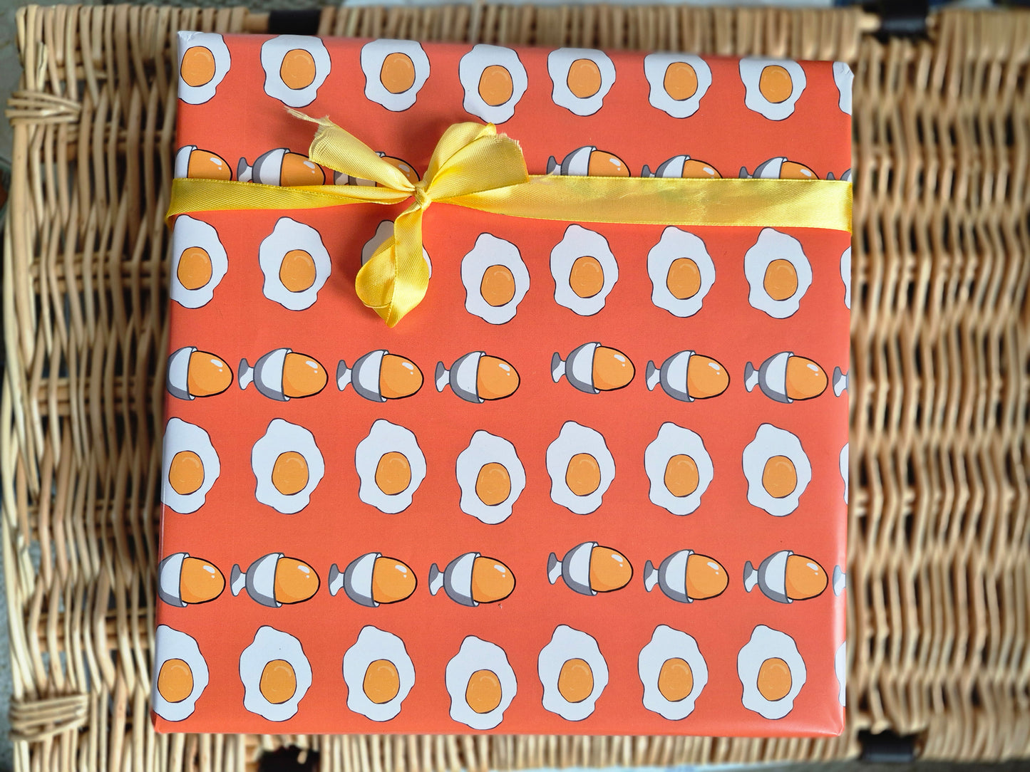 Orange wrapping paper with an egg print design