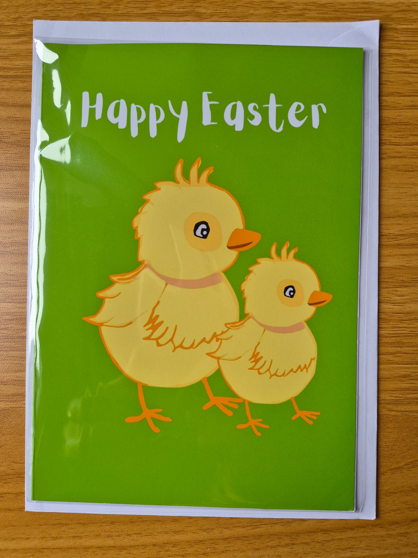 Easter card with chicks and 'Happy Easter' text on a green background