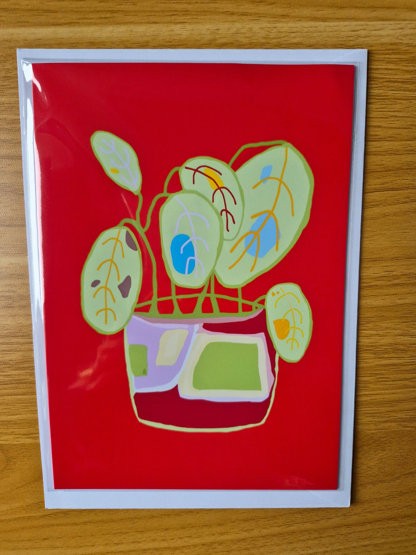 Botanical pot plant greetings card with a red background
