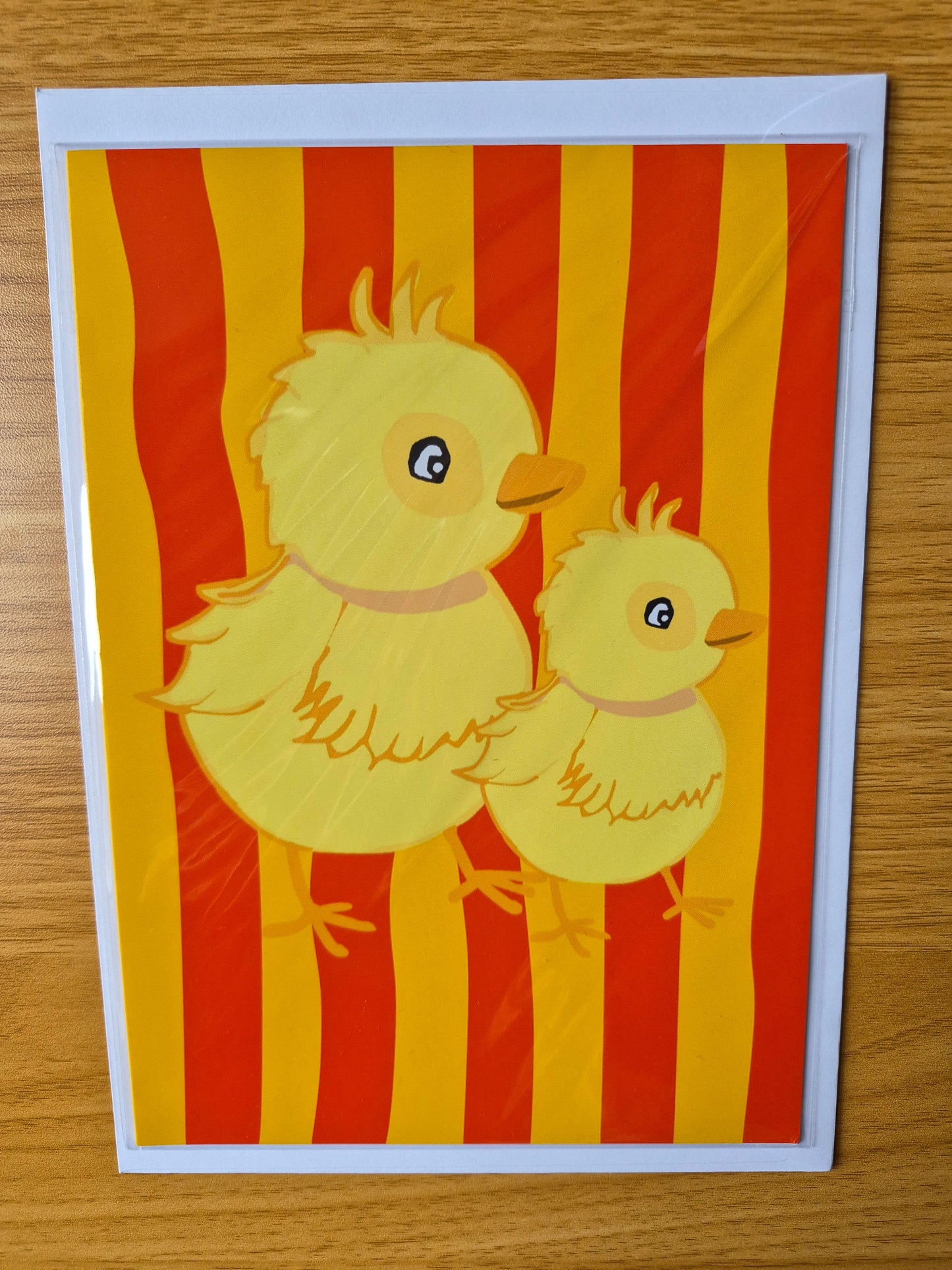 Easter chick card featuring two chicks on a bright red and orange striped background 