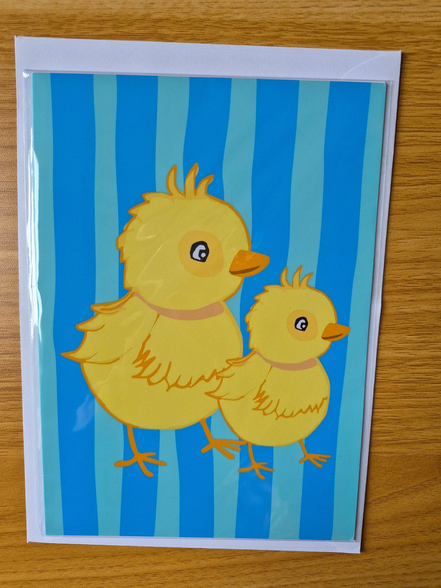 Cartoon ducklings on a blue striped background. Cute Easter greetings card 
