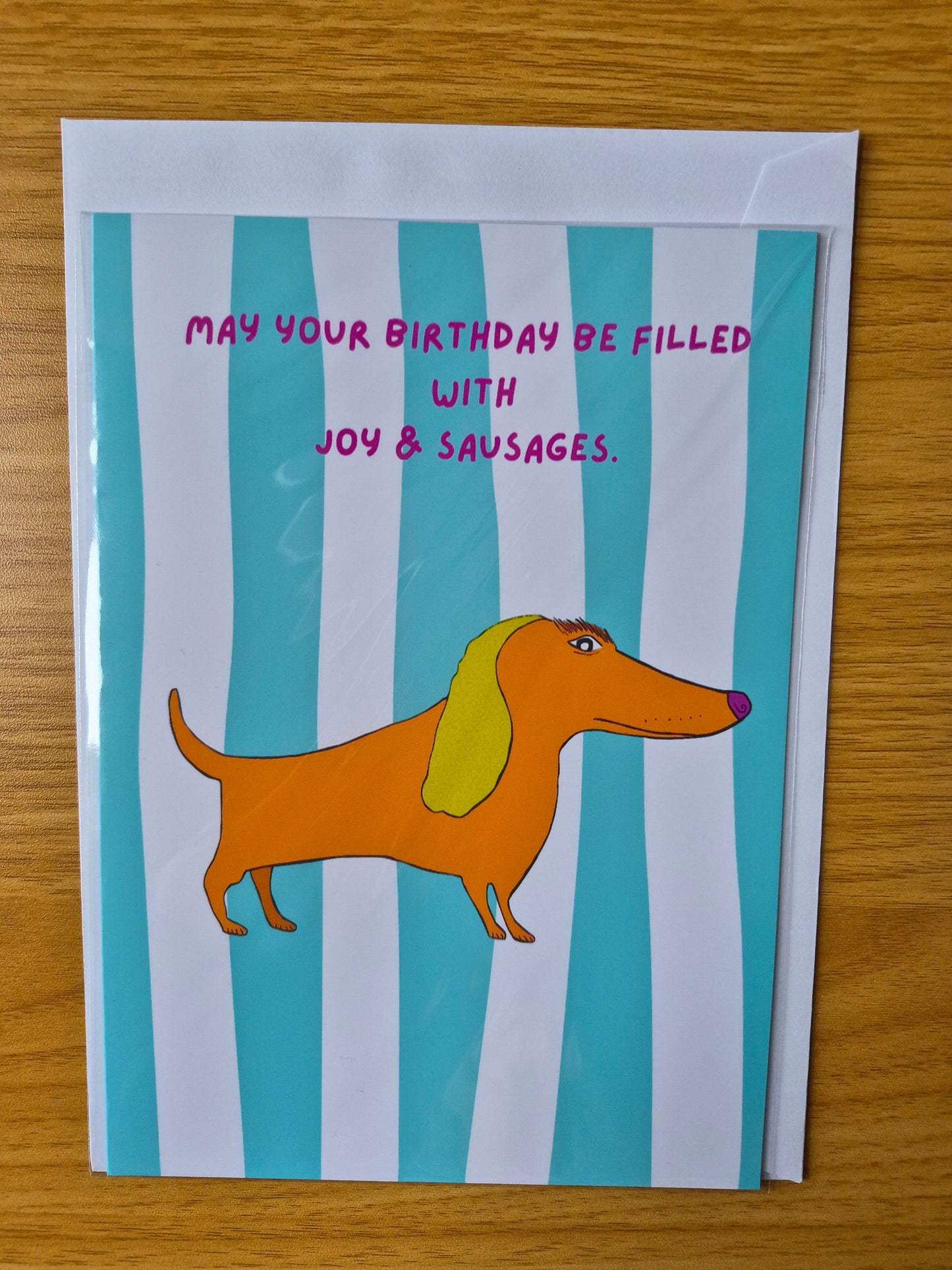 Birthday card with cartoon dog and text on a striped background