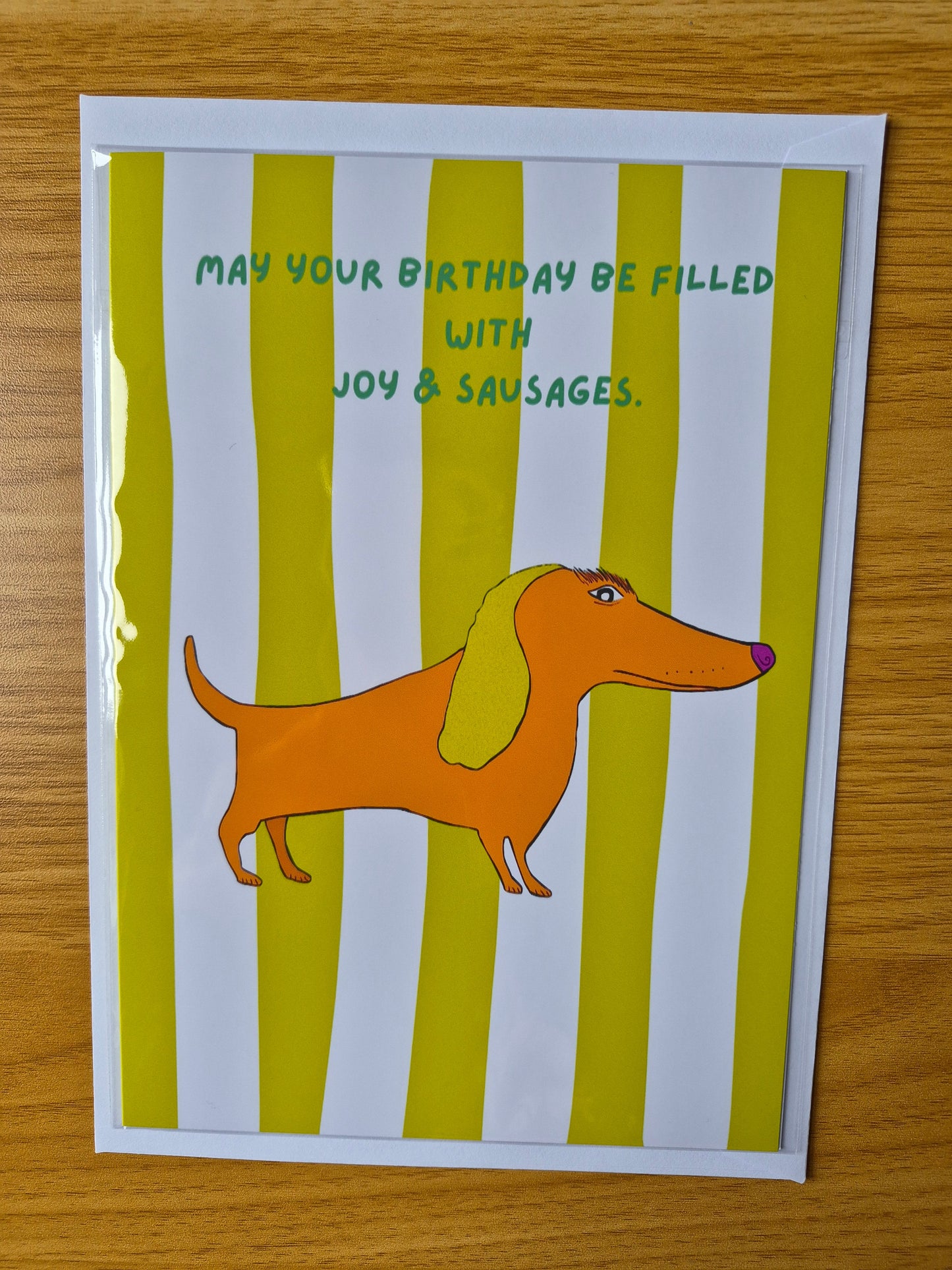 Birthday card with a cartoon dog and text on a striped background