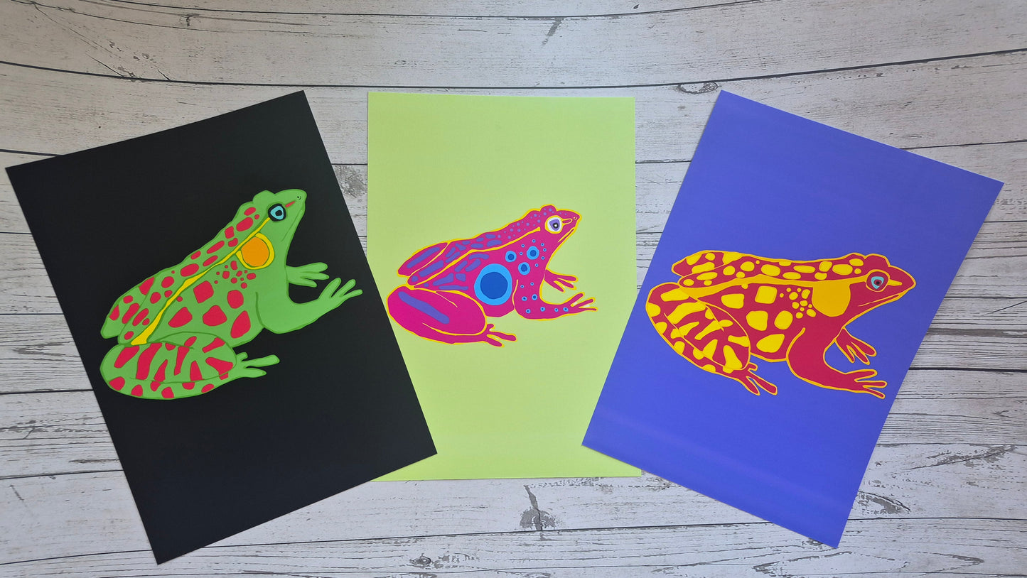 Three u frog print illustrations on black, green, and purple cards.