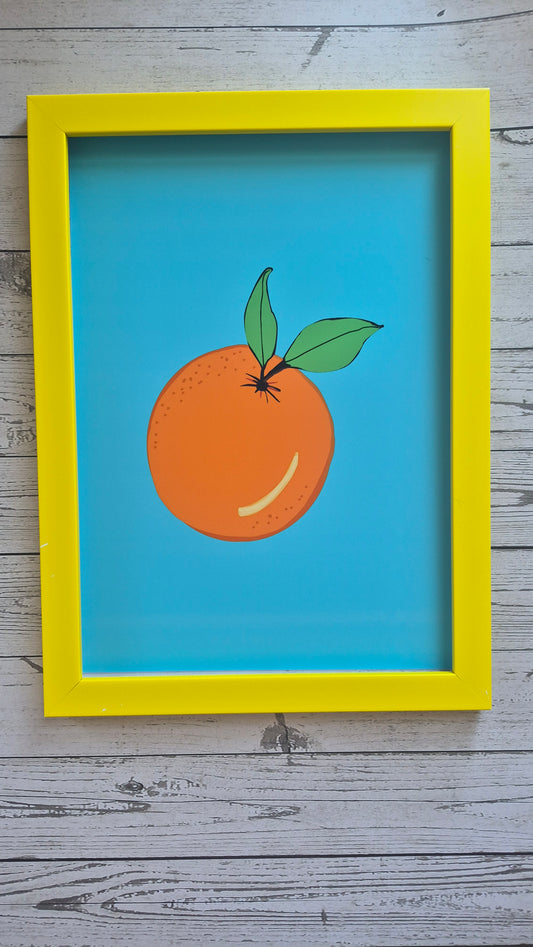 Yellow framed art print of an orange. A solid sky blue background. 