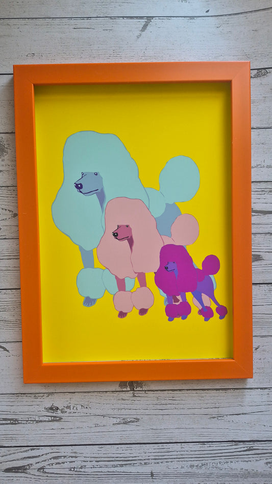 Framed abstract poodle artwork with colorful poodle dogs on a yellow background. Framed in an orange frame. 