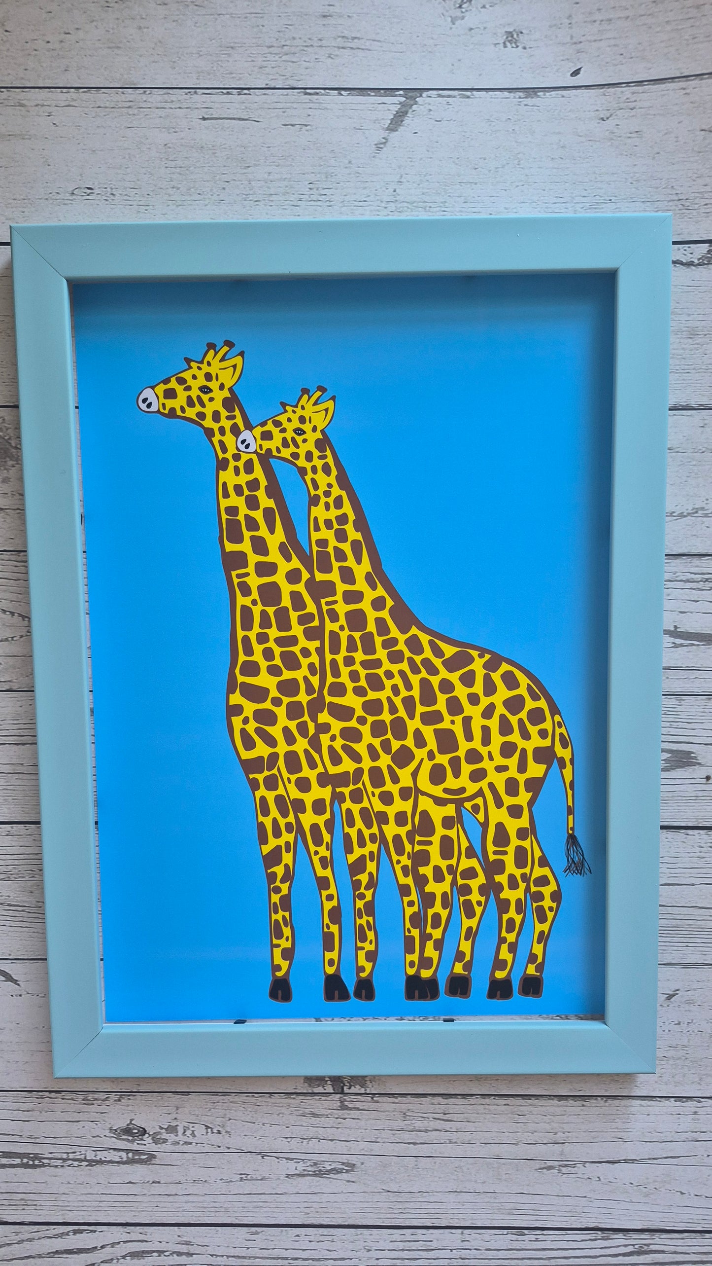 Framed artwork of a stylized giraffe on a blue background