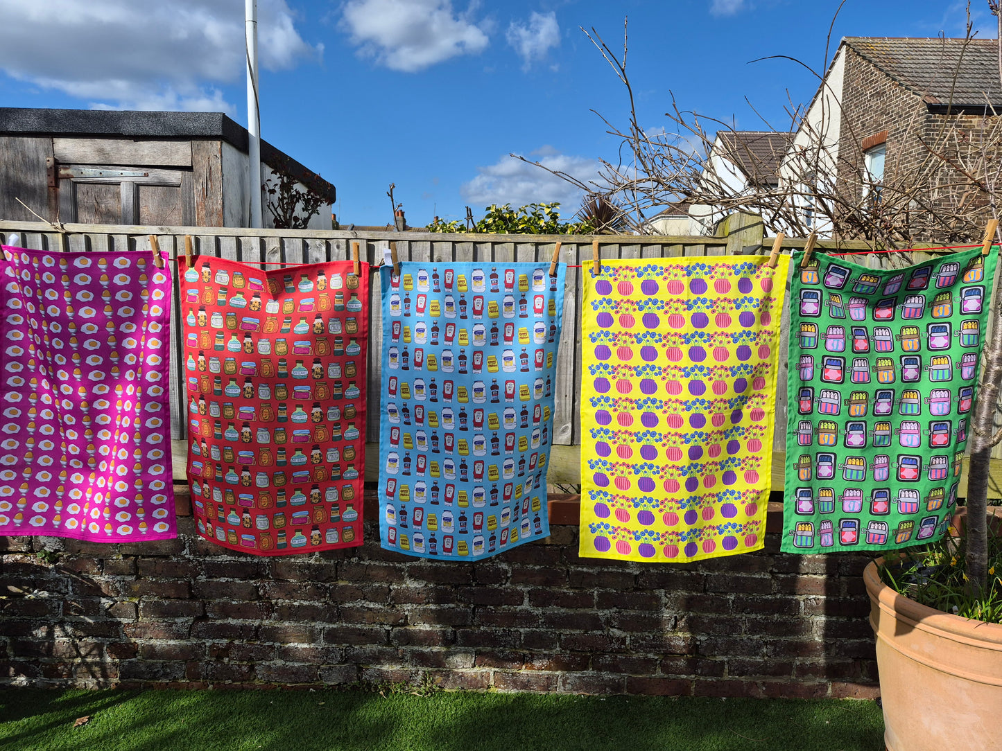 Colourful tea towels hanging on the washing line. 