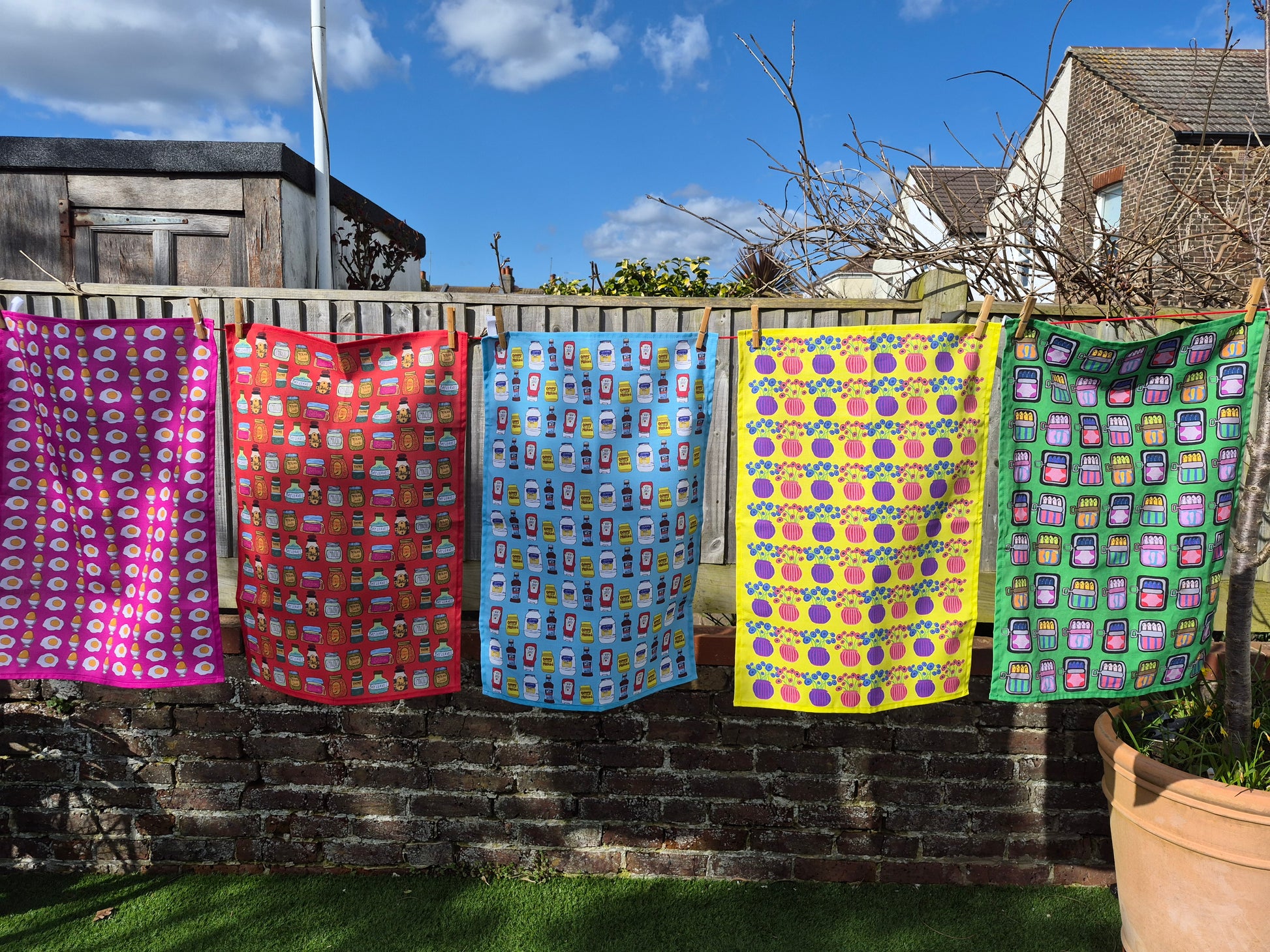 Colourful tea towels hanging on the washing line. 