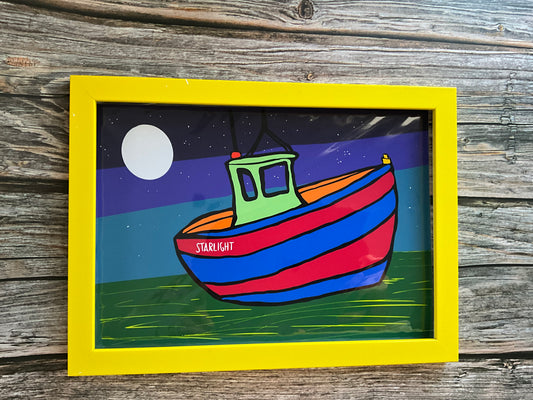 Colorful boat illustration with a yellow frame on a wooden surface