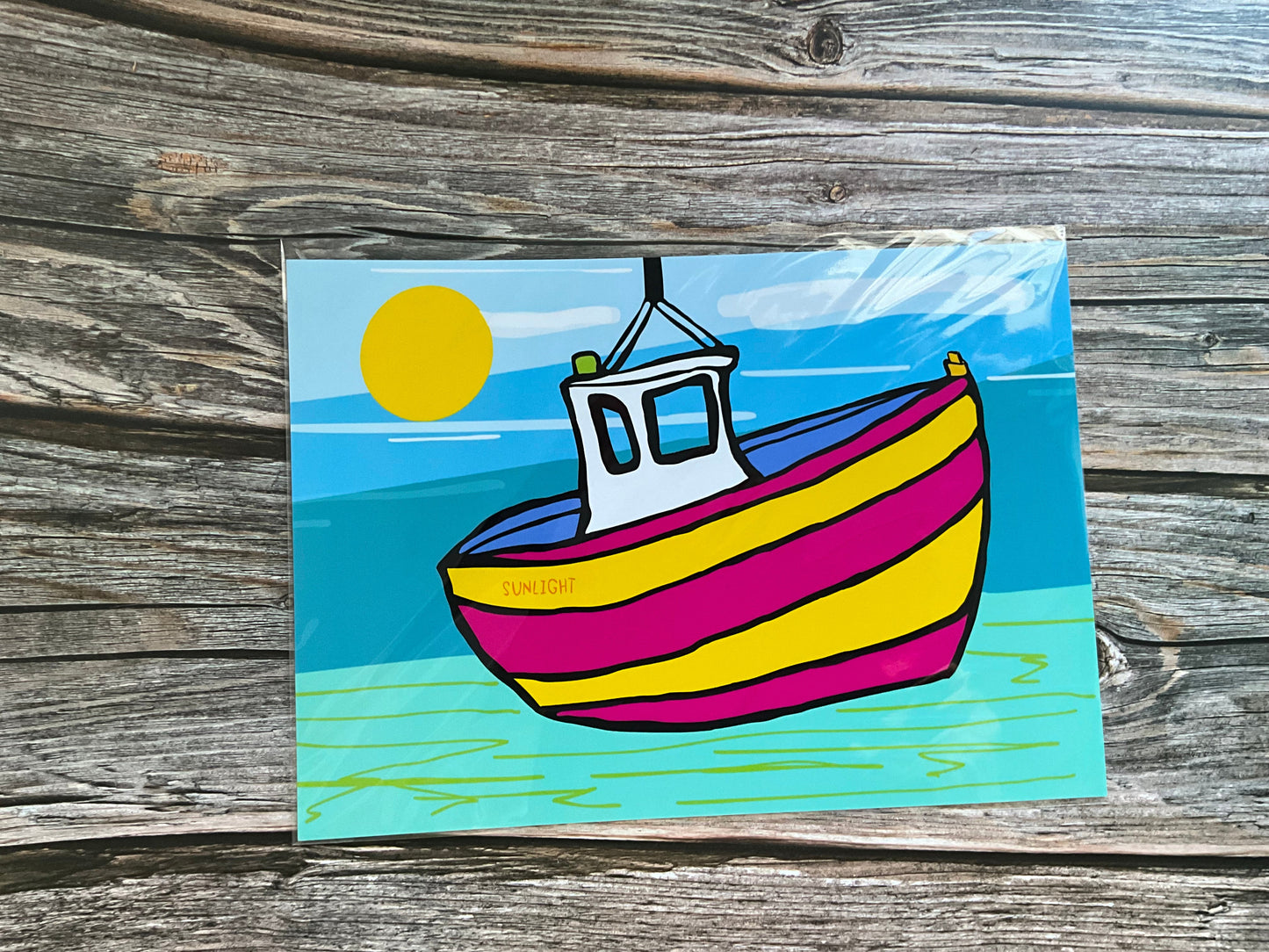 Colourful striped boat art boat on a wooden surface