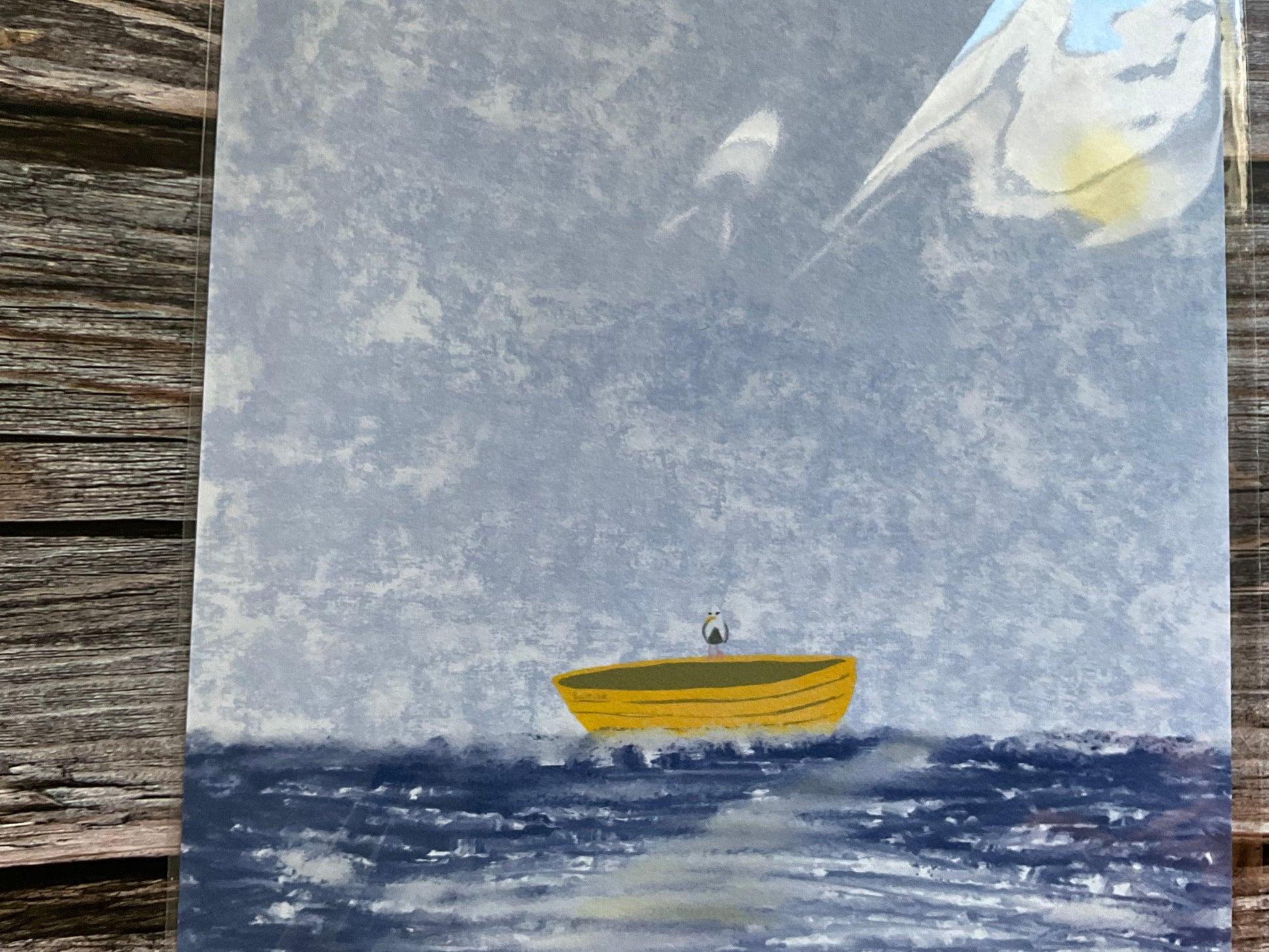 Art print of a seagull perched on a little yellow board in the middle of the sea. 