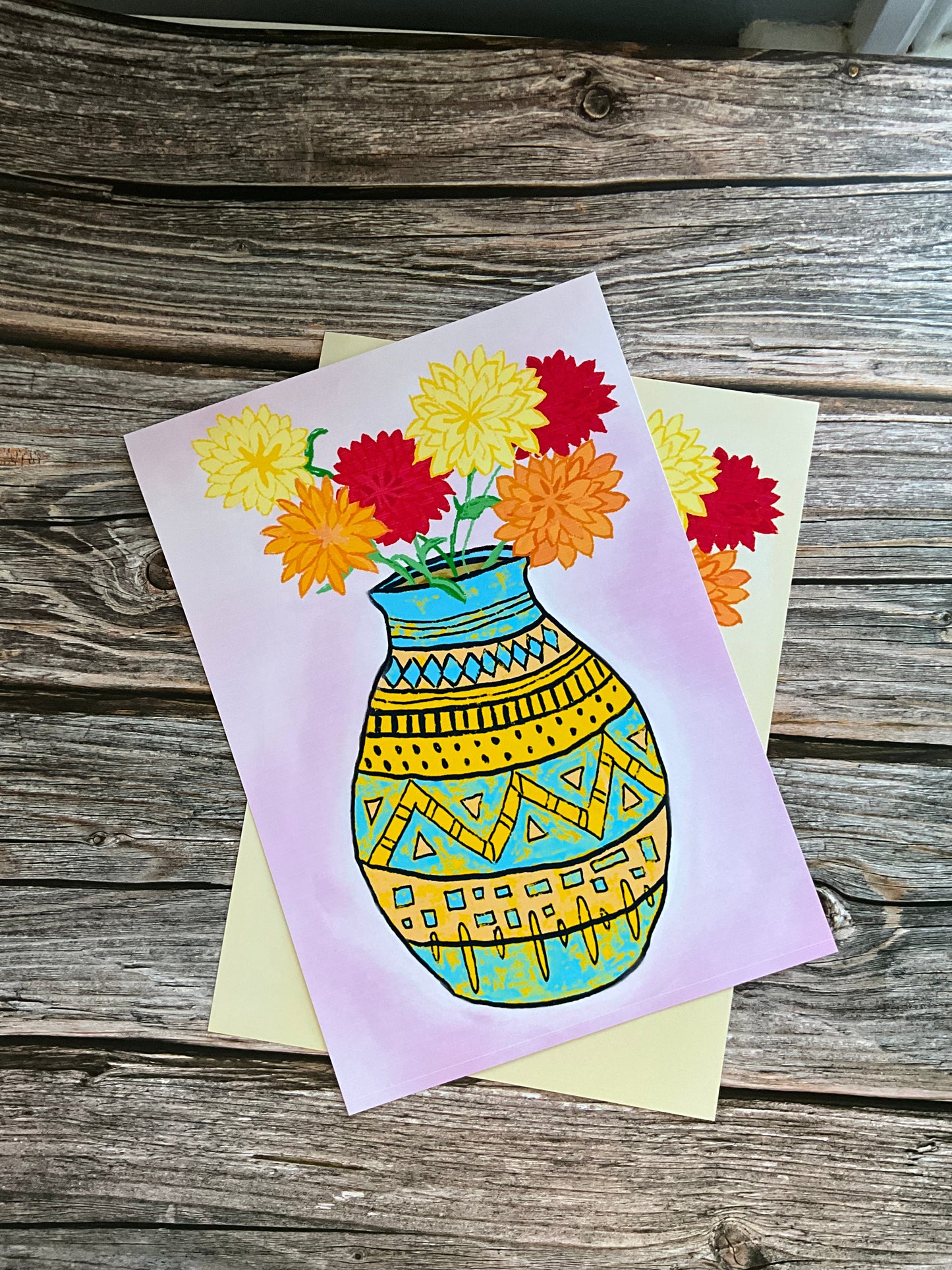 Colorful card with a floral design and geometric pattern on a wooden surface