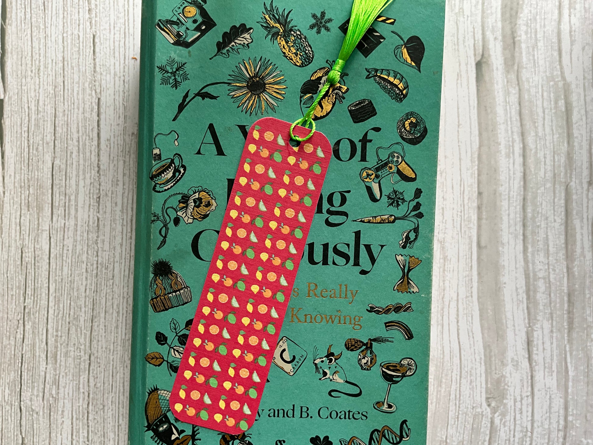Book with a citrus fruit design bookmark on a wooden surface
