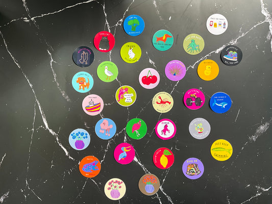 Colorful circular stickers on a black marble surface