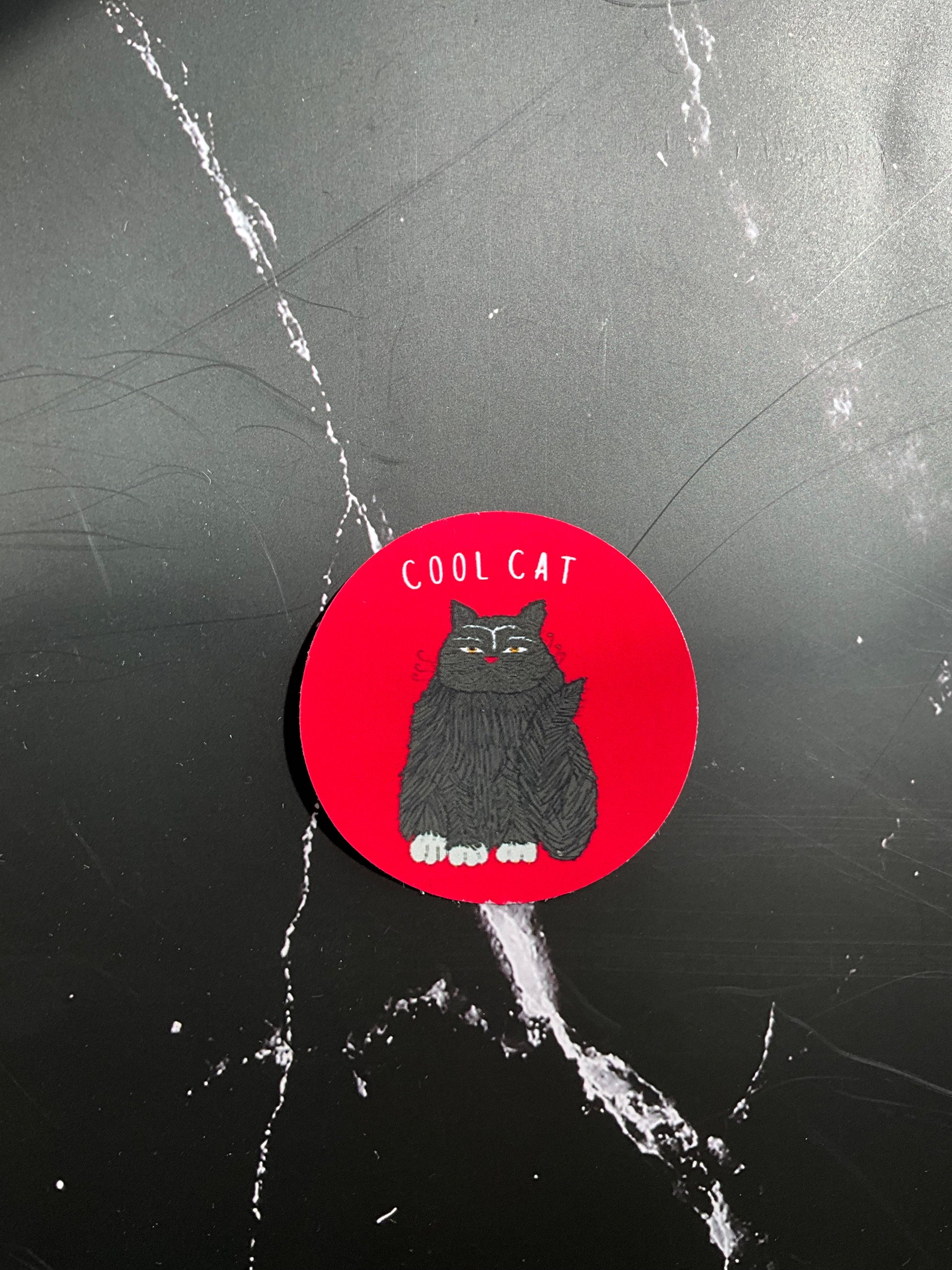 Red vinyl sticker featuring a funny black cat with the words ‘cool cat’ at the top.