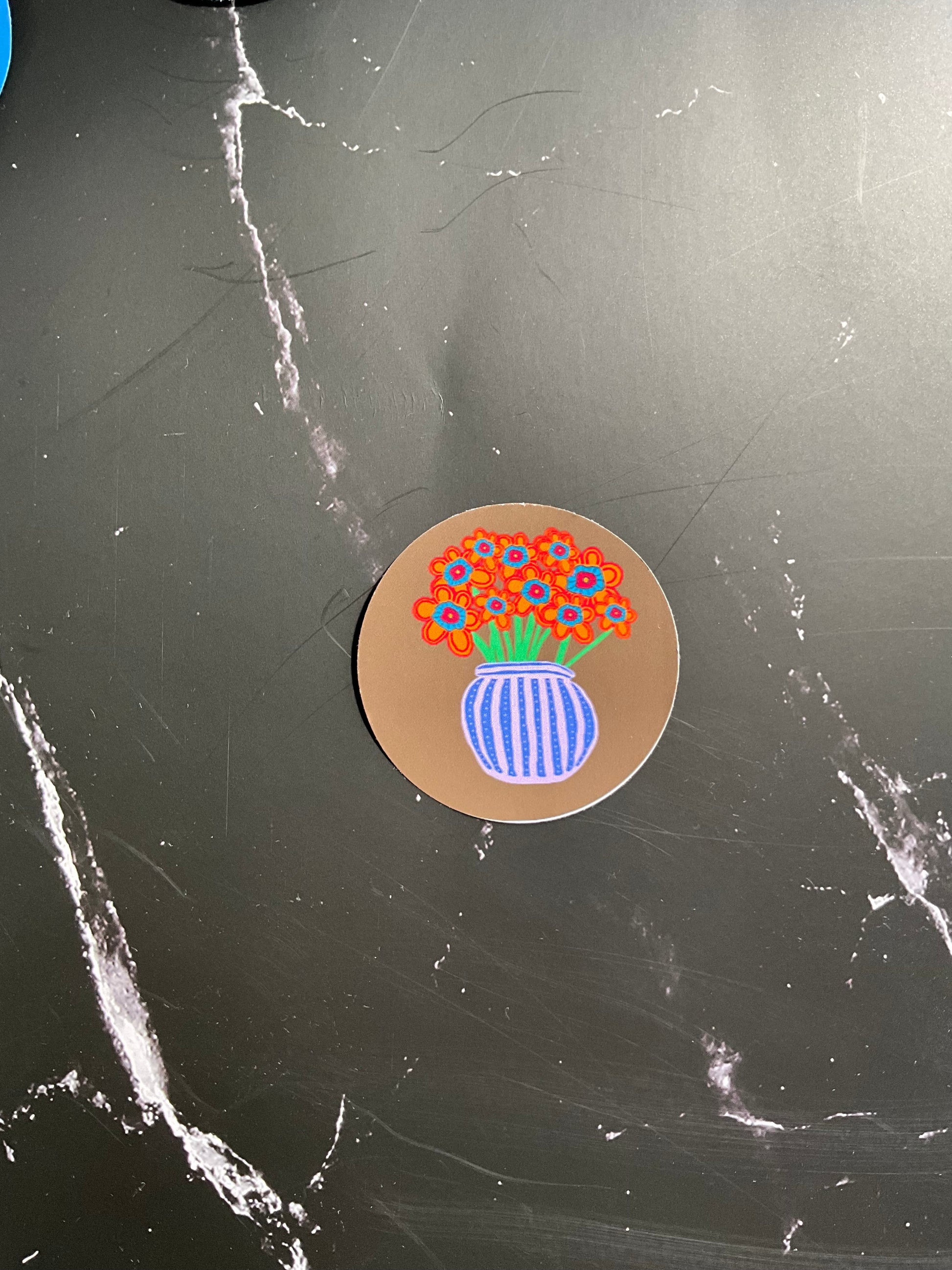 Blue striped vase with orange flowers on a round vinyl sticker