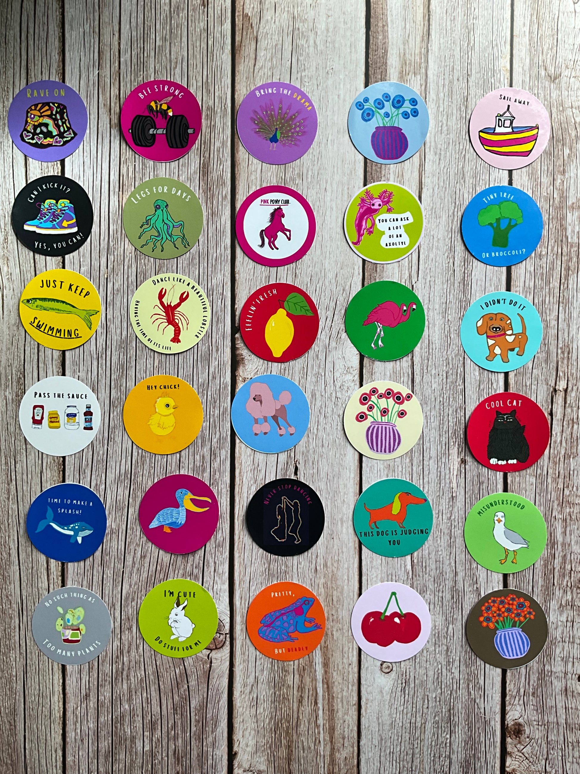 Colourful vinyl stickers with various designs on a wooden surface