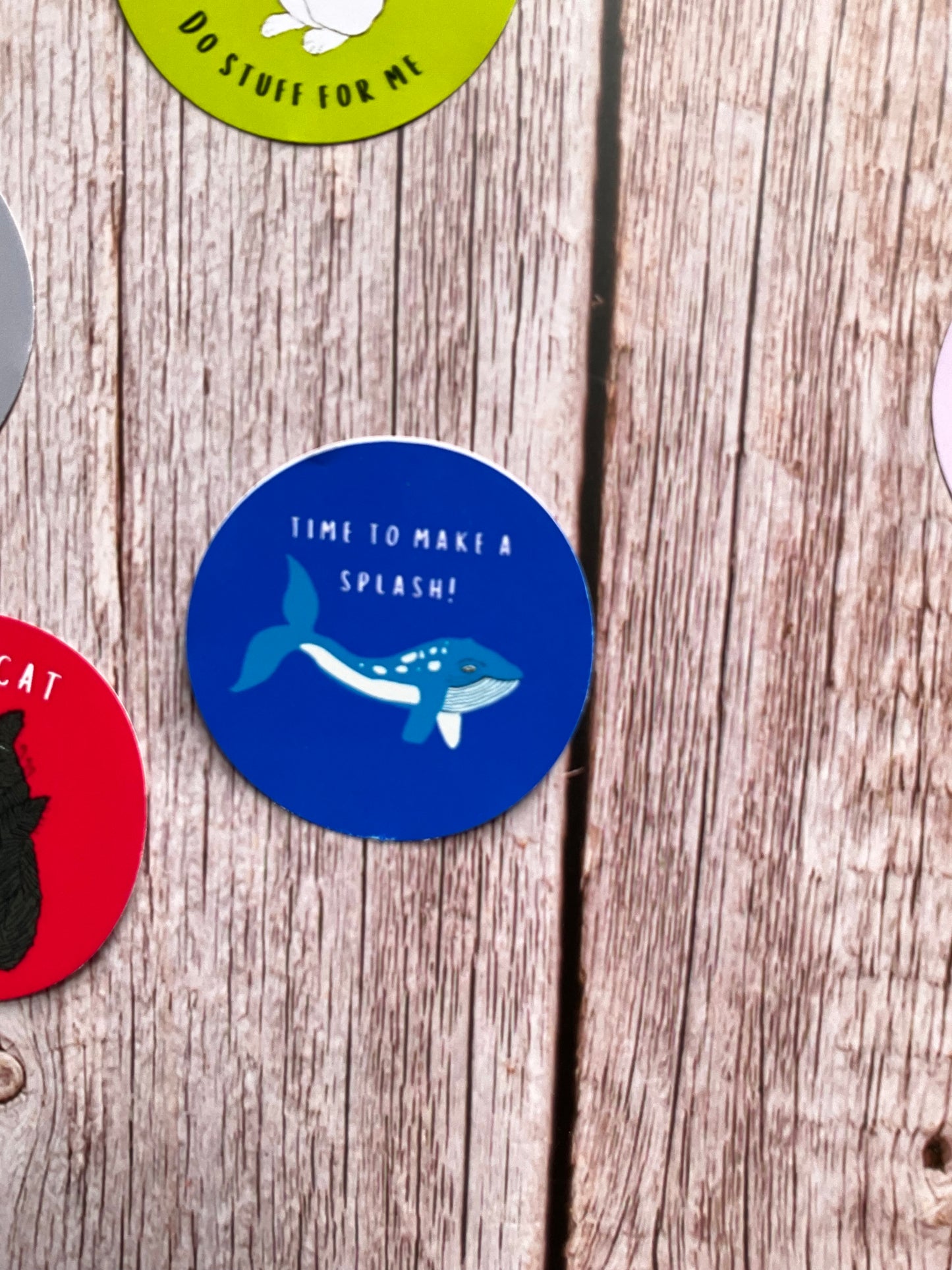 Blue round vinyl sticker with what design and the words ‘time to make a splash’