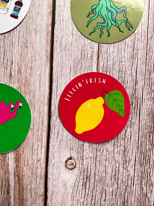Colorful circular stickers with different designs on a wooden surface