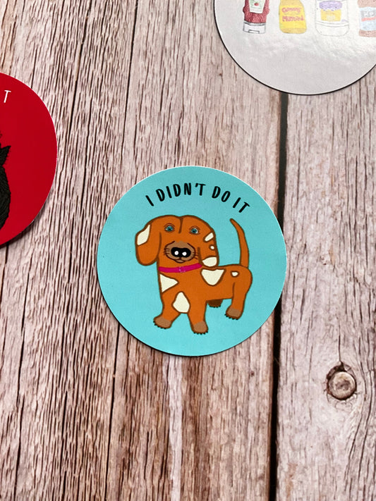 Cheeky dachshund vinyl sticker - round, blue sticker with the words ‘I didn’t do it’