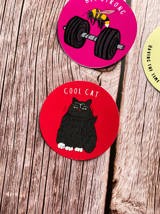 Red vinyl sticker featuring a cartoon cat and the text ‘cool cat’