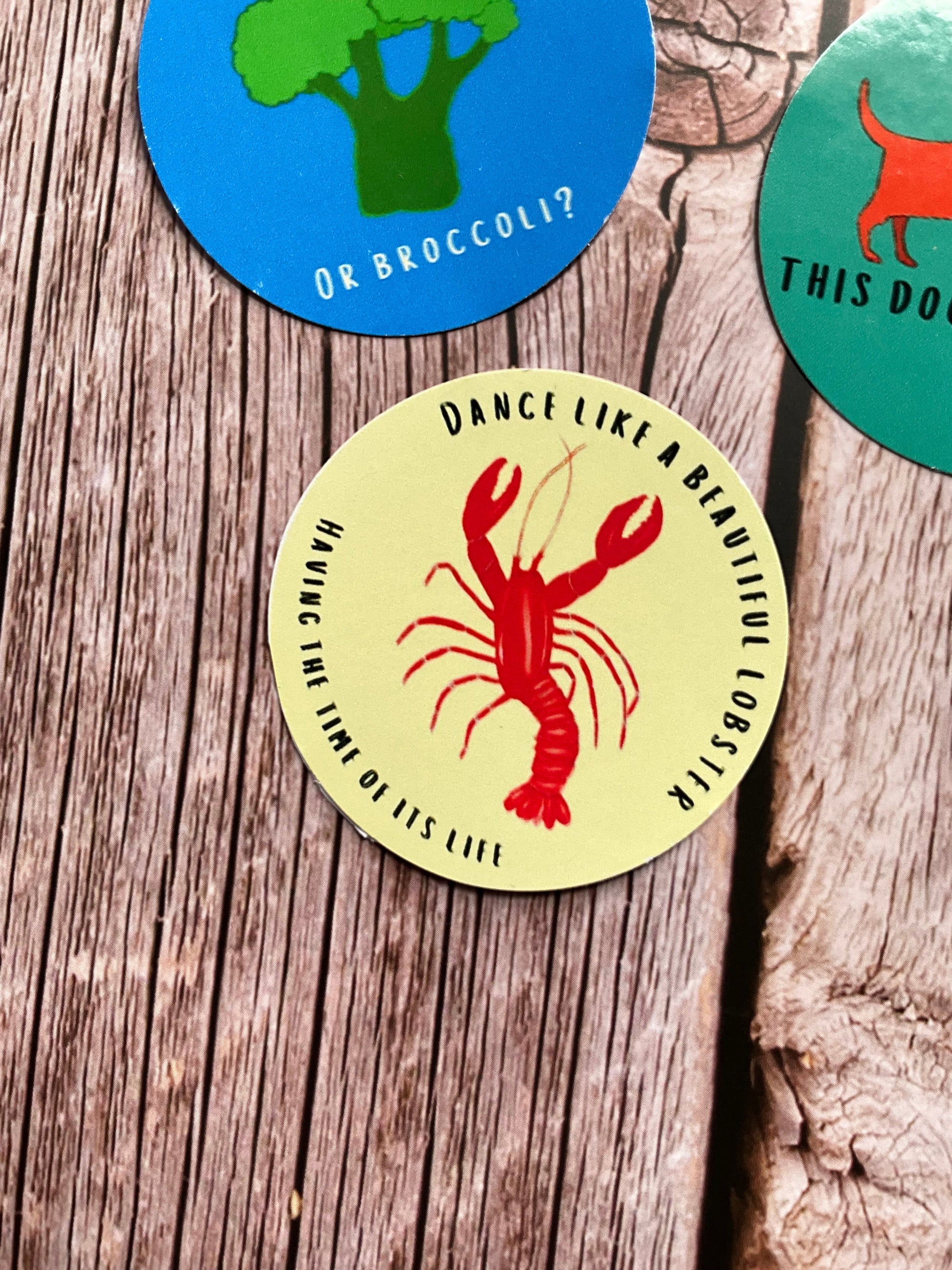 A pale yellow vinyl sticker with lobster illustration