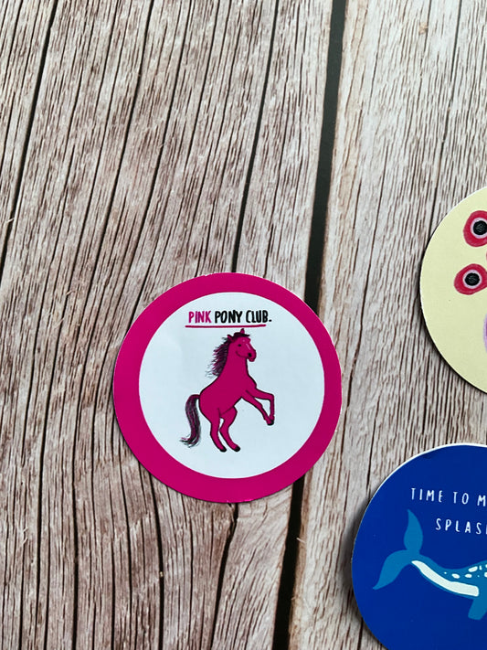 Round pink and white vinyl sticker featuring, a pink outline & pink pony with the words ‘pink pony club’ underlined above