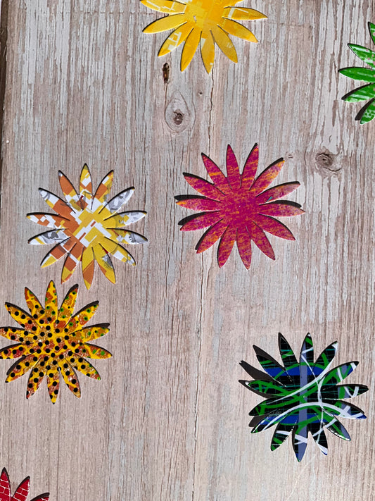 Various colourful sunflower shaped vinyl stickers on a wooden background