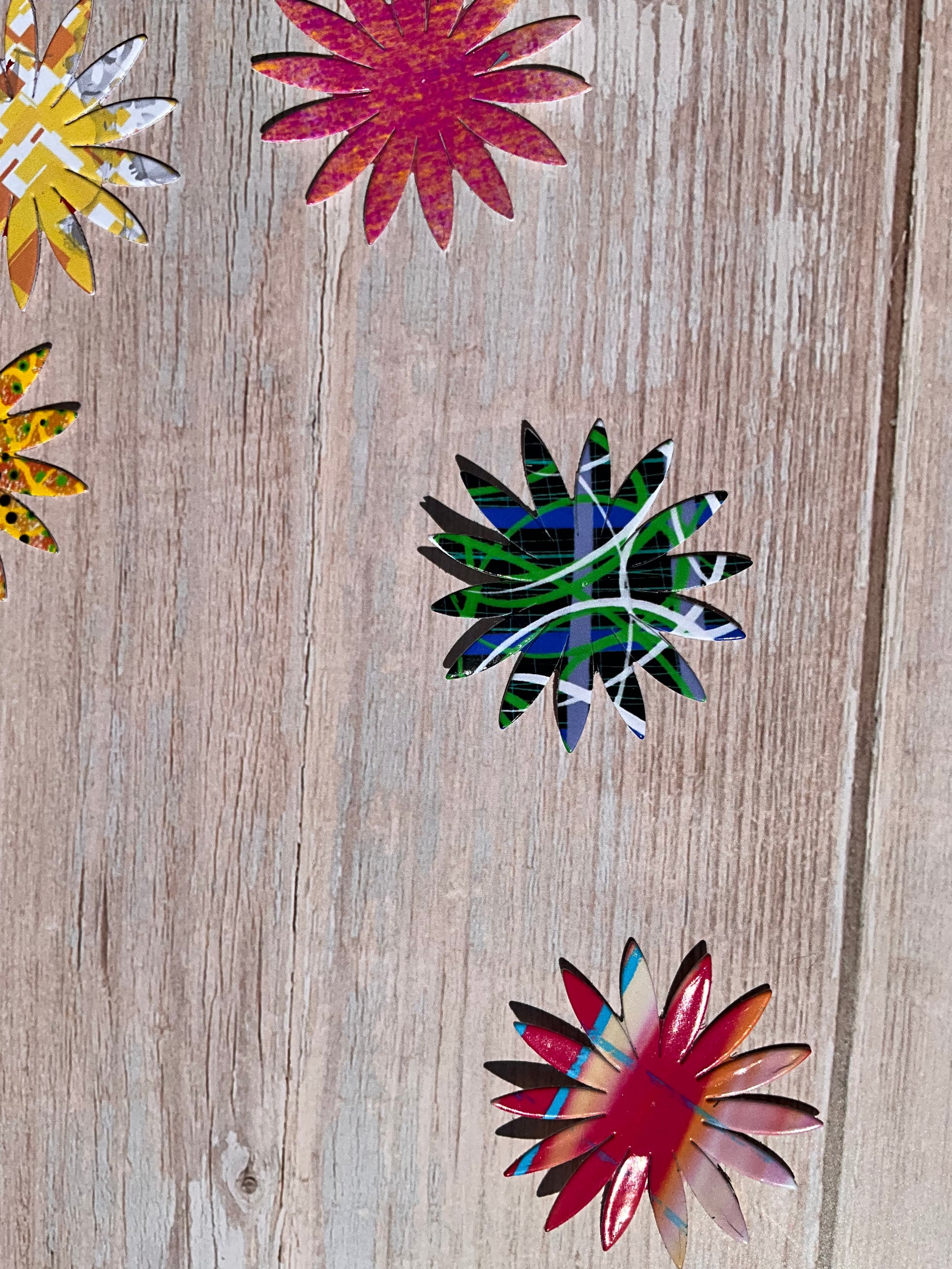 Colourful flower stickers on a wooden background