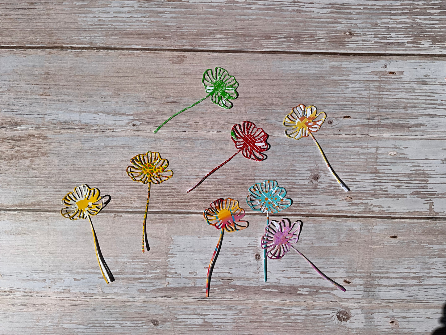 Vinyl daisy stickers in bright colours on a wooden table 