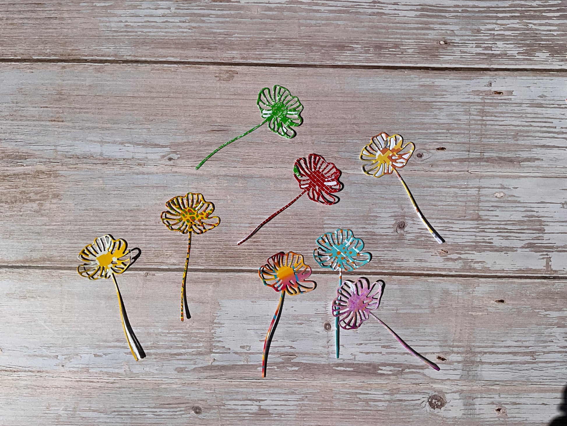 Vinyl daisy stickers in bright colours on a wooden table 