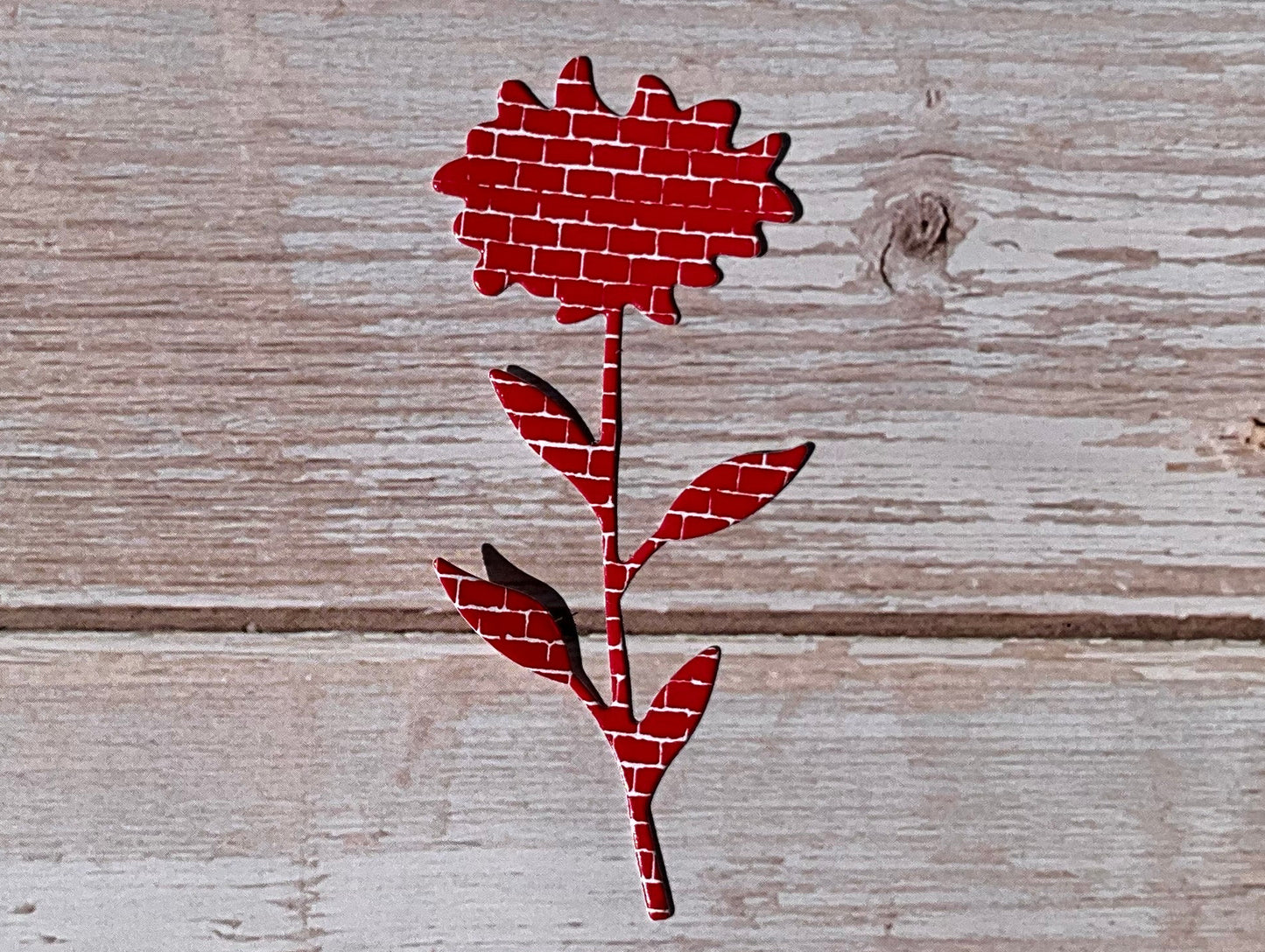 Red sunflower shaped vinyl sticker on wooden panels