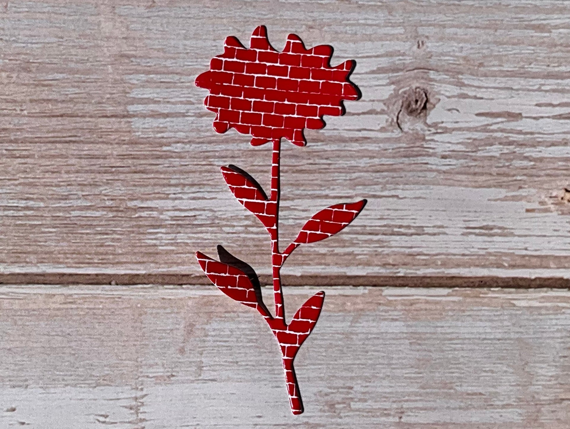 Red sunflower shaped vinyl sticker on wooden panels