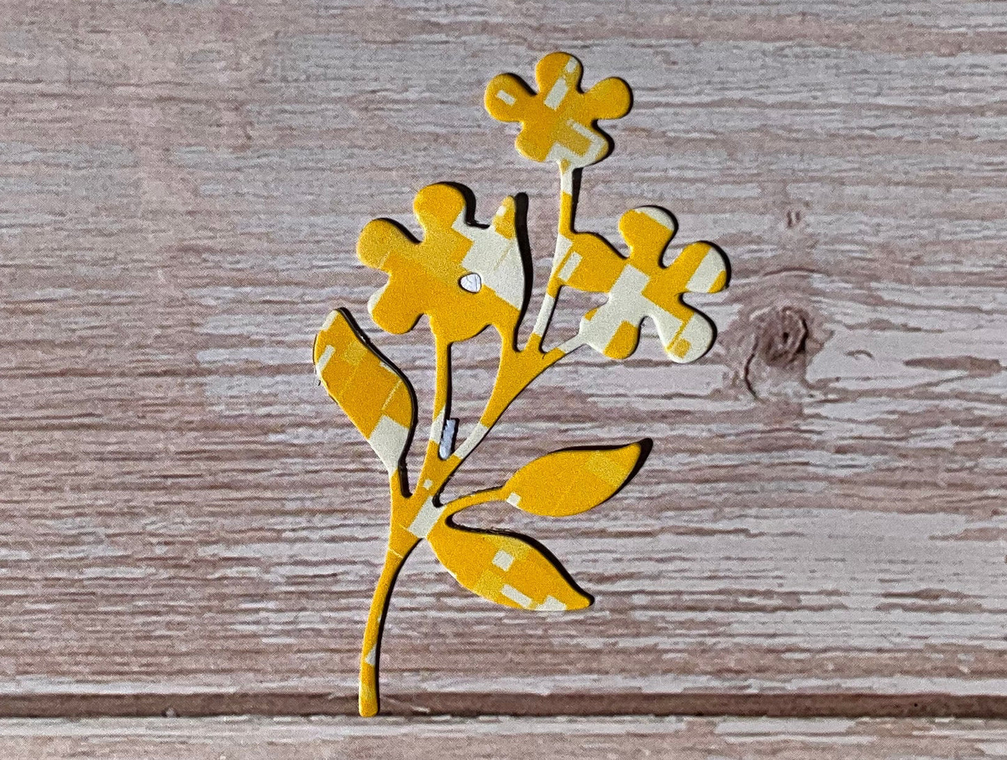 Yellow buttercup flower stickers on wood
