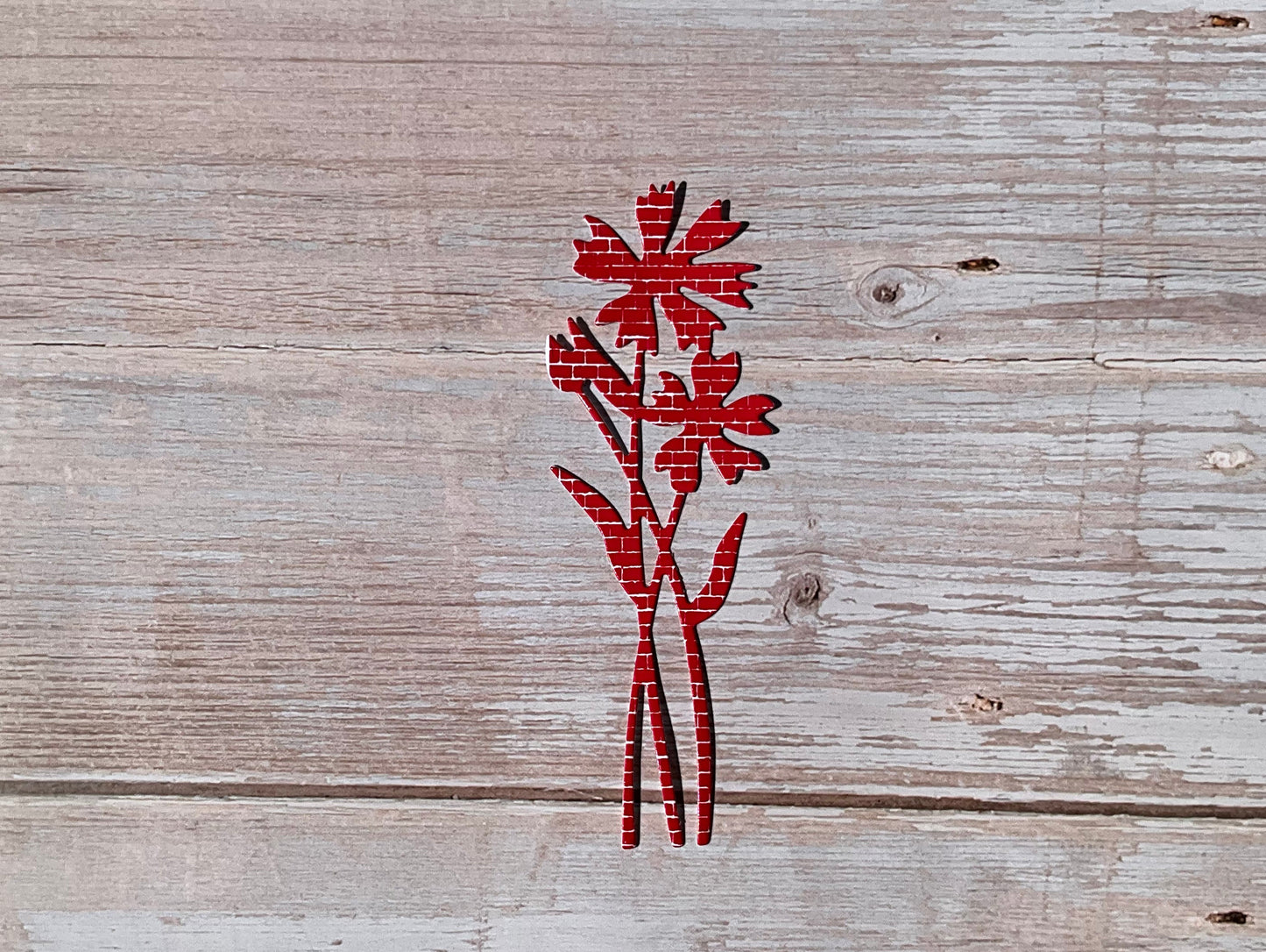 Red fie cut vinyl sticker in the shape of a cornflower
