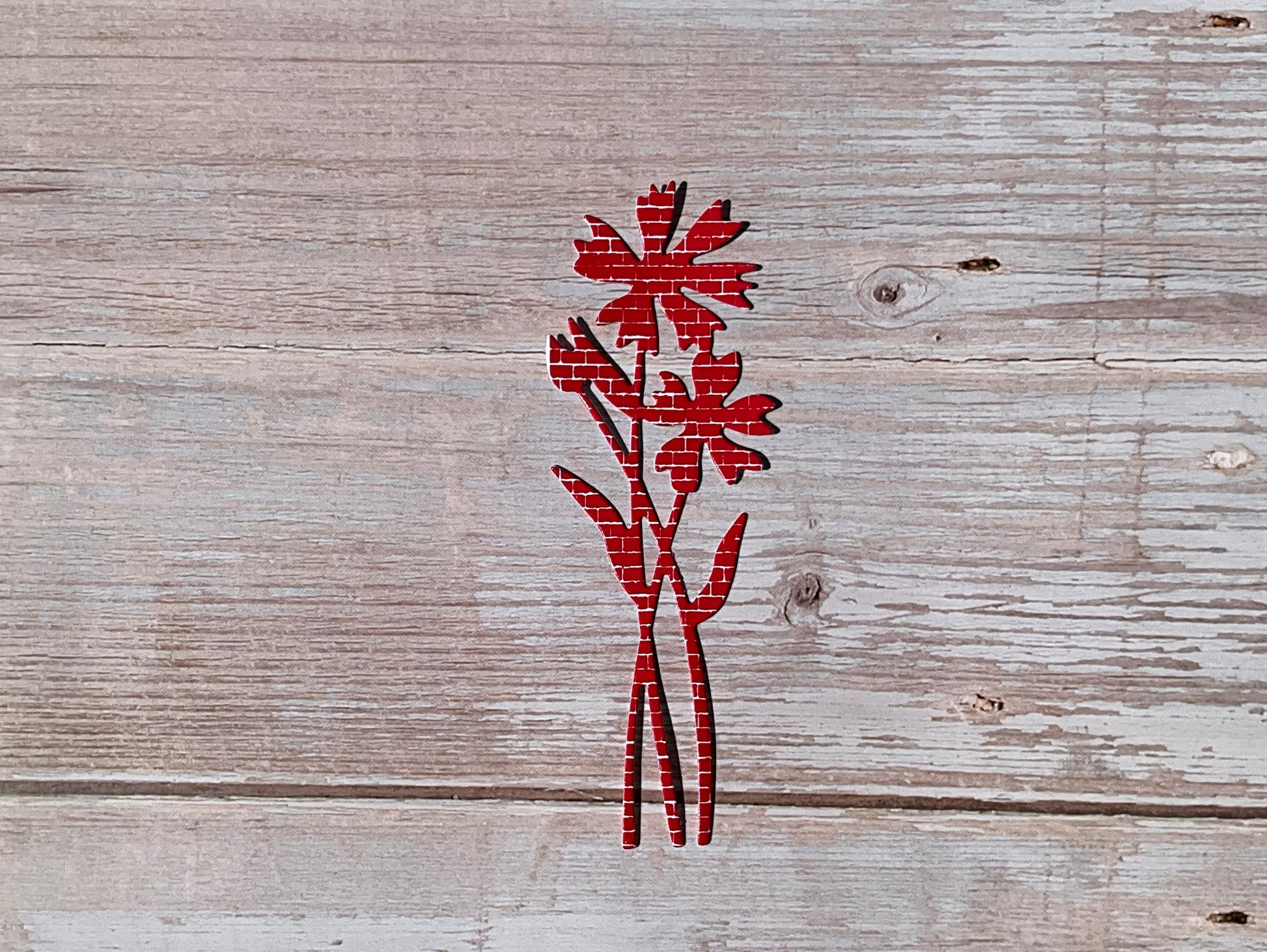 Red fie cut vinyl sticker in the shape of a cornflower