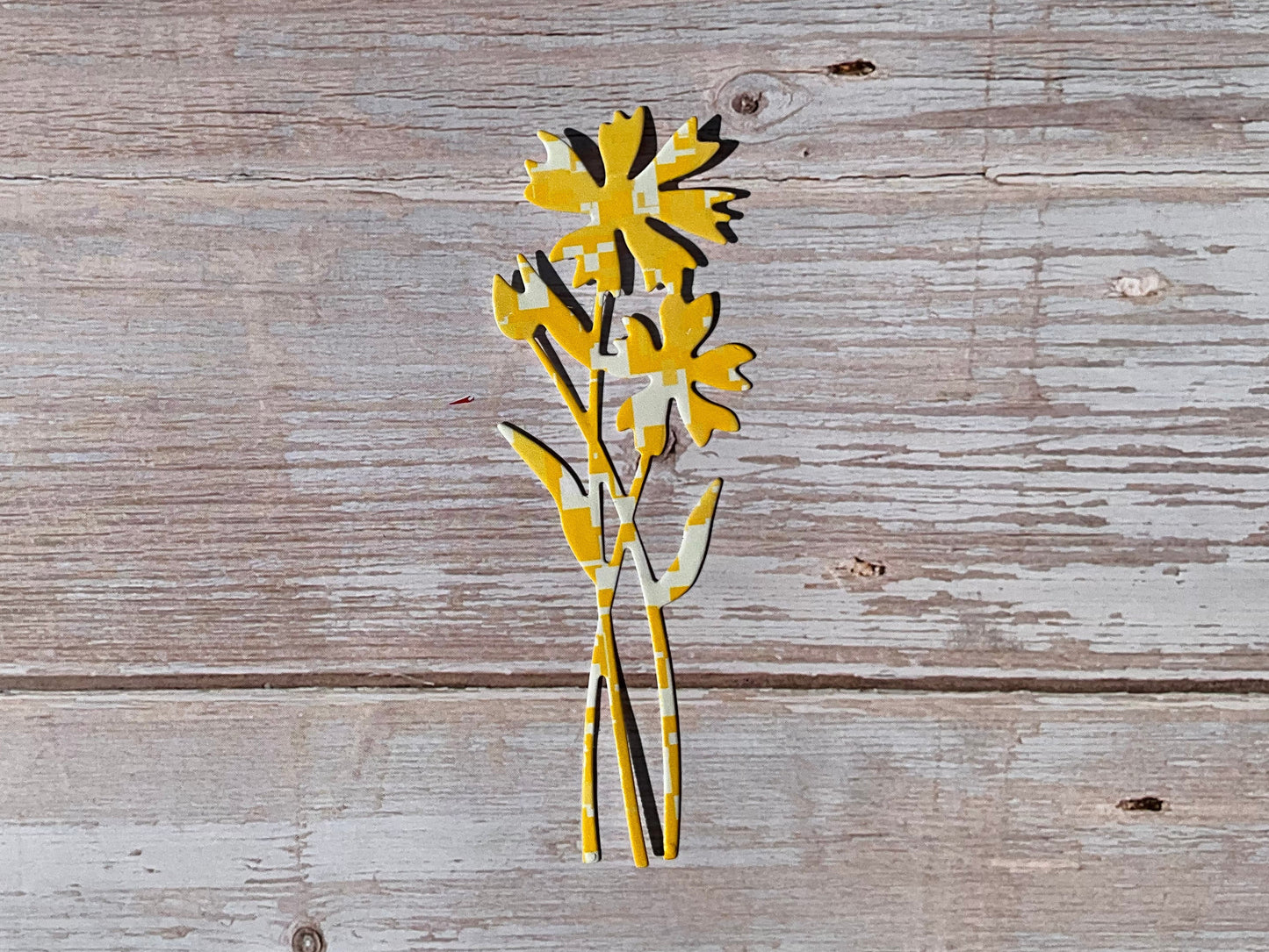 Yellow die cut sticker in the shape of cornflowers. 