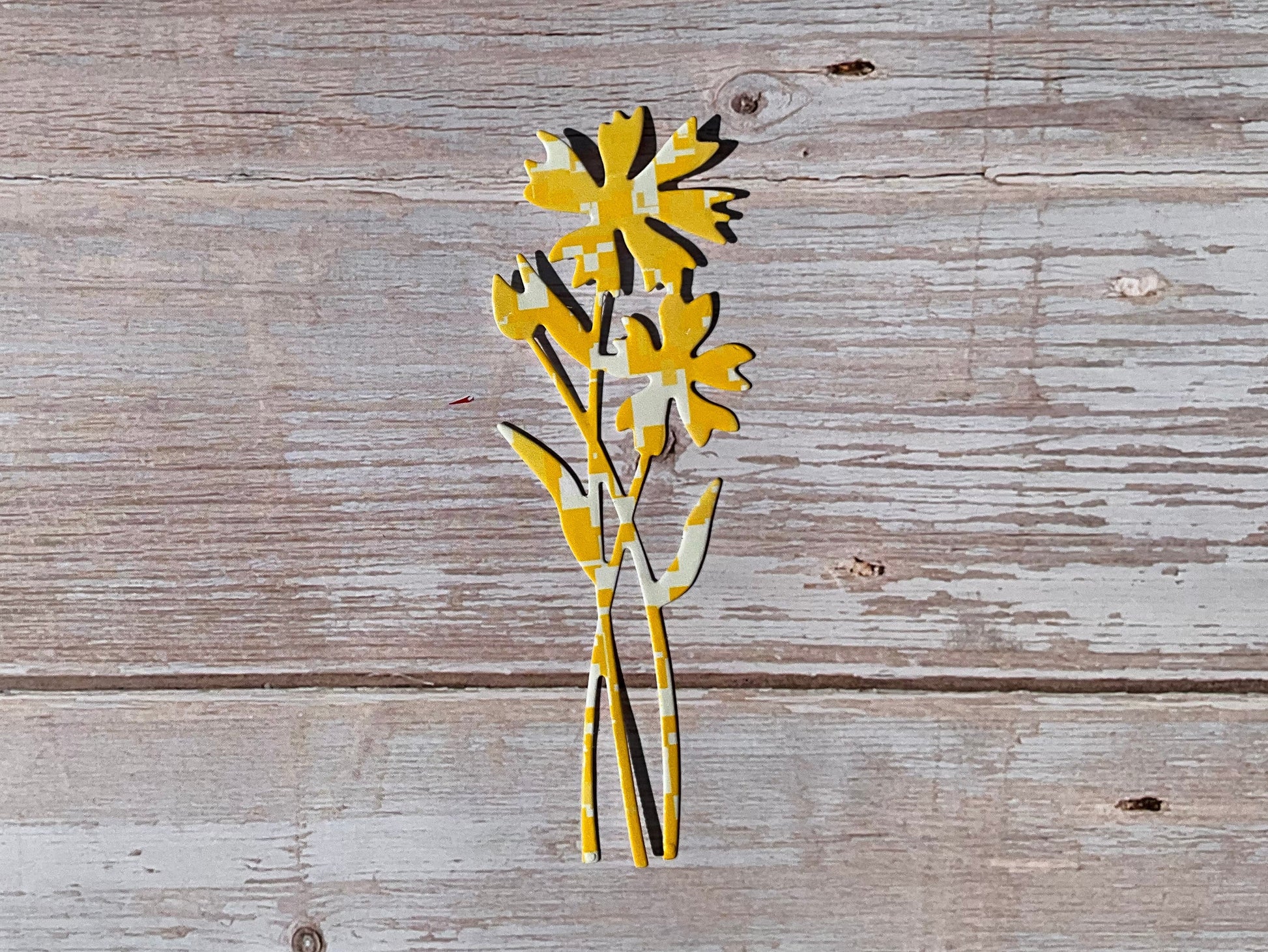 Yellow die cut sticker in the shape of cornflowers. 