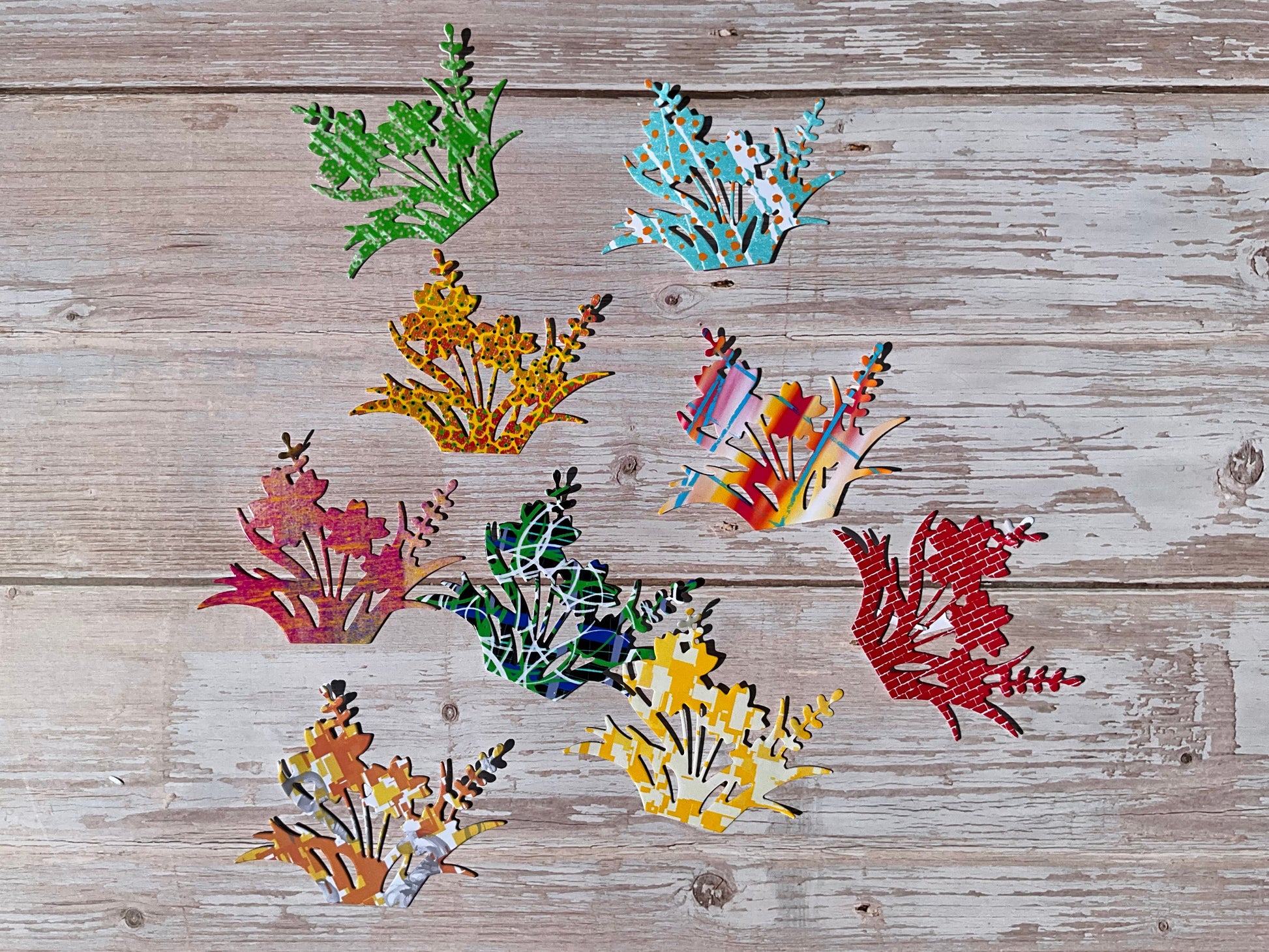 A selection of flower silhouette vinyl stickers on a wooden background