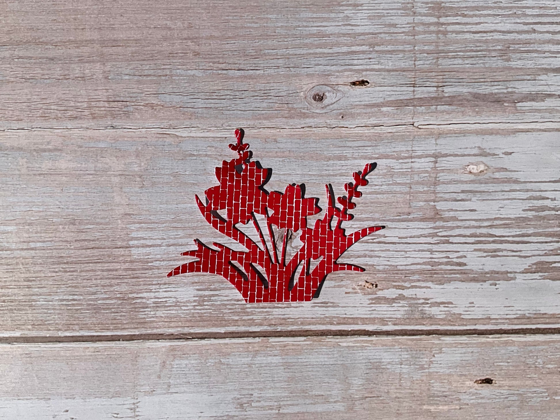 Red floral sticker on a wooden table