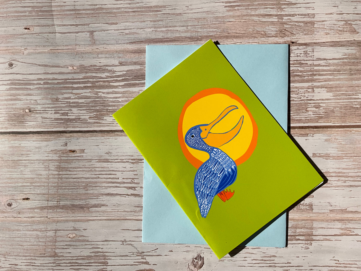 Blue patterned pelican greetings card with yellow sun. Unique greetings card, hand-designed in the UK