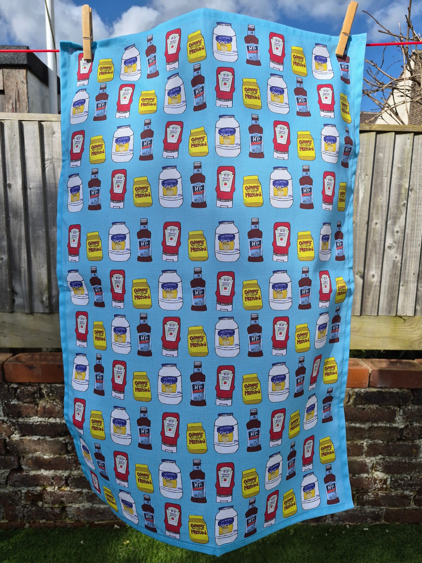 blue printed  tea towel hanging on a washing line