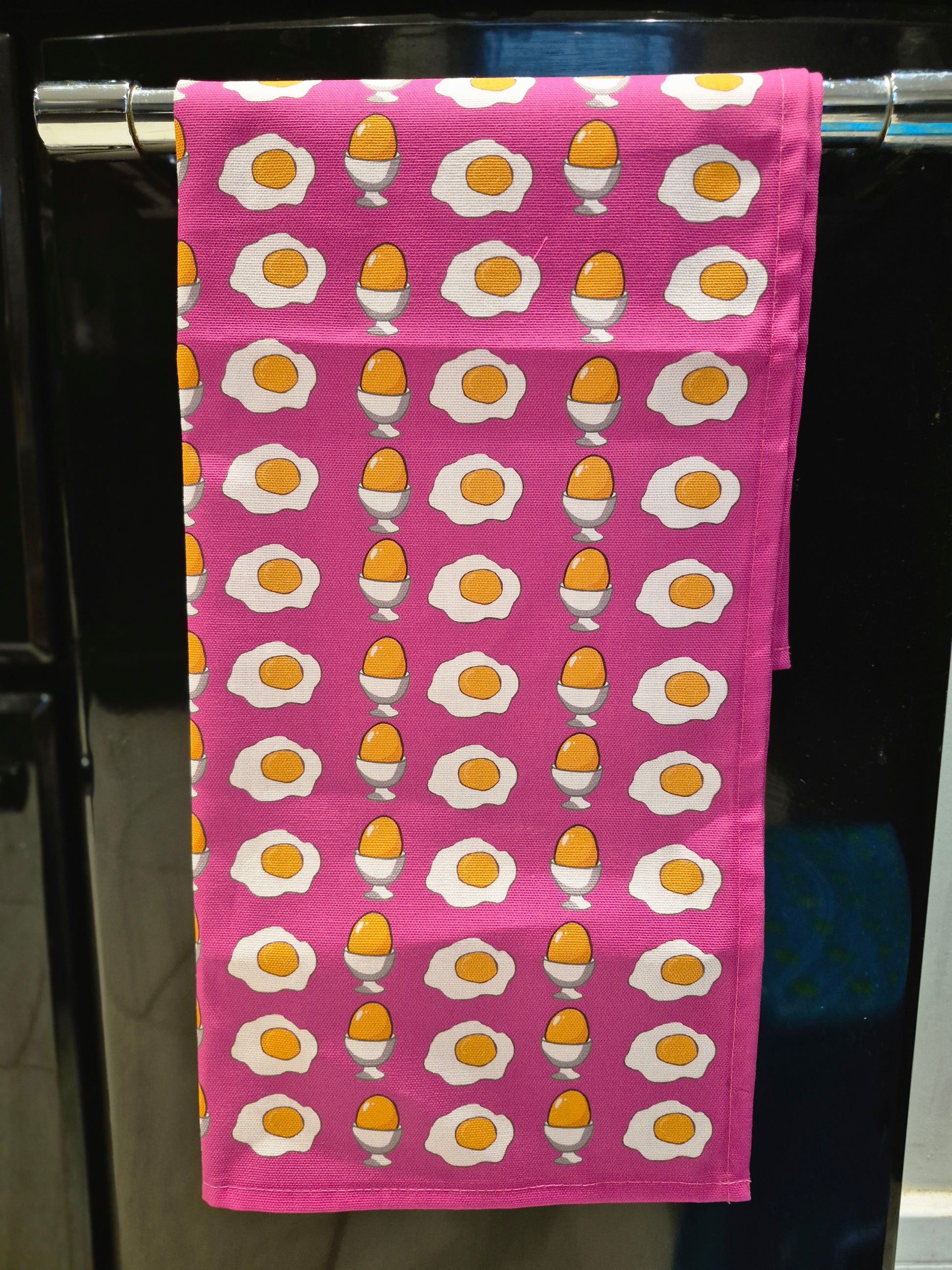 Pink unique egg print tea towel on oven