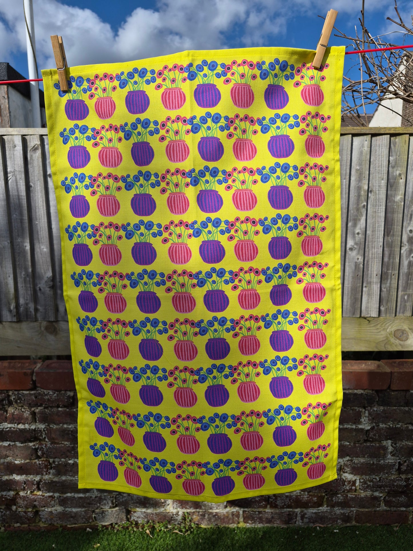 bright yellow tea towel with striped floral vase pattern