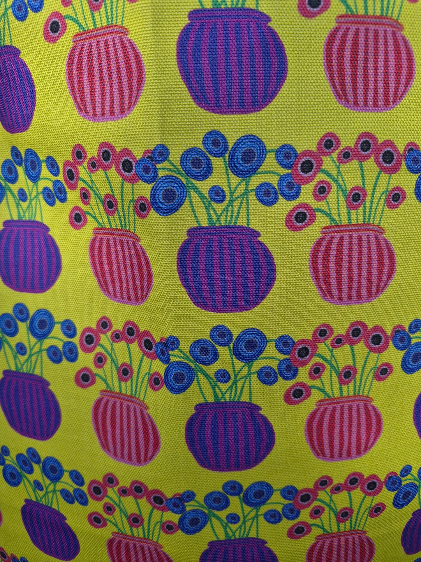 close up of flower vase pattern on a yellow tea towel