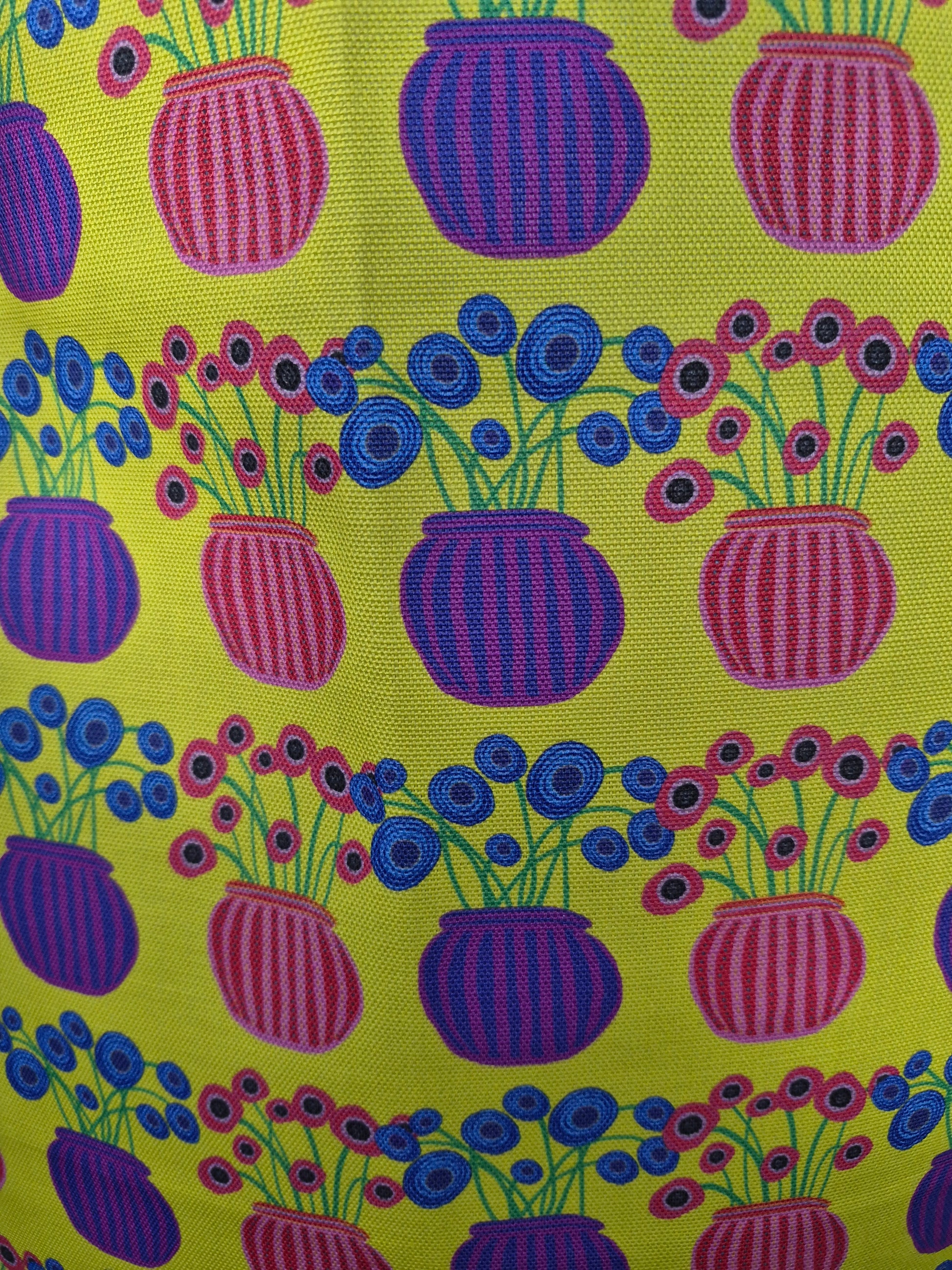 close up of flower vase pattern on a yellow tea towel